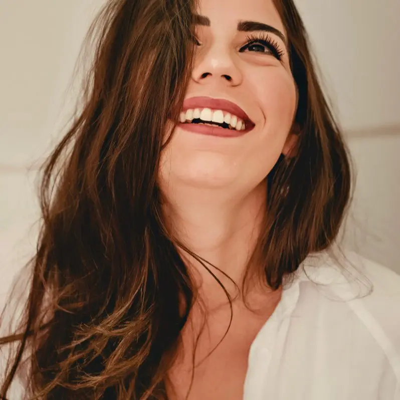 A woman with long hair smiling at the camera.